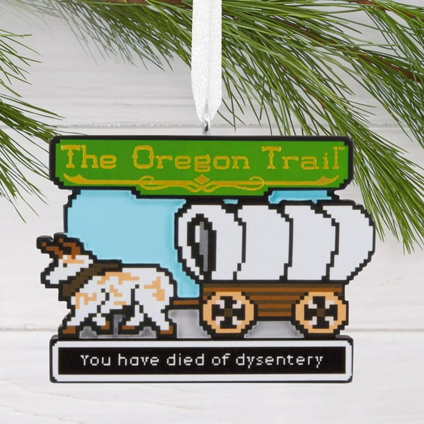 etro gaming Oregon Trail Christmas ornament hanging on a decorated tree.
