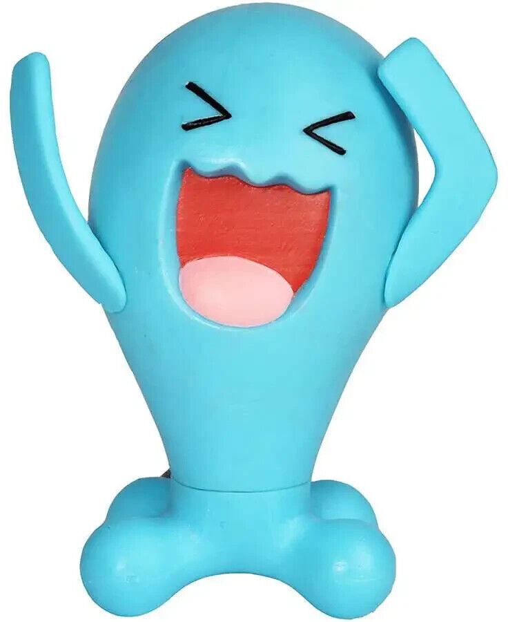 A colorful plastic action figure of the Pokemon Wobbuffet, featuring a happy facial expression and a pose suggesting movement or action.